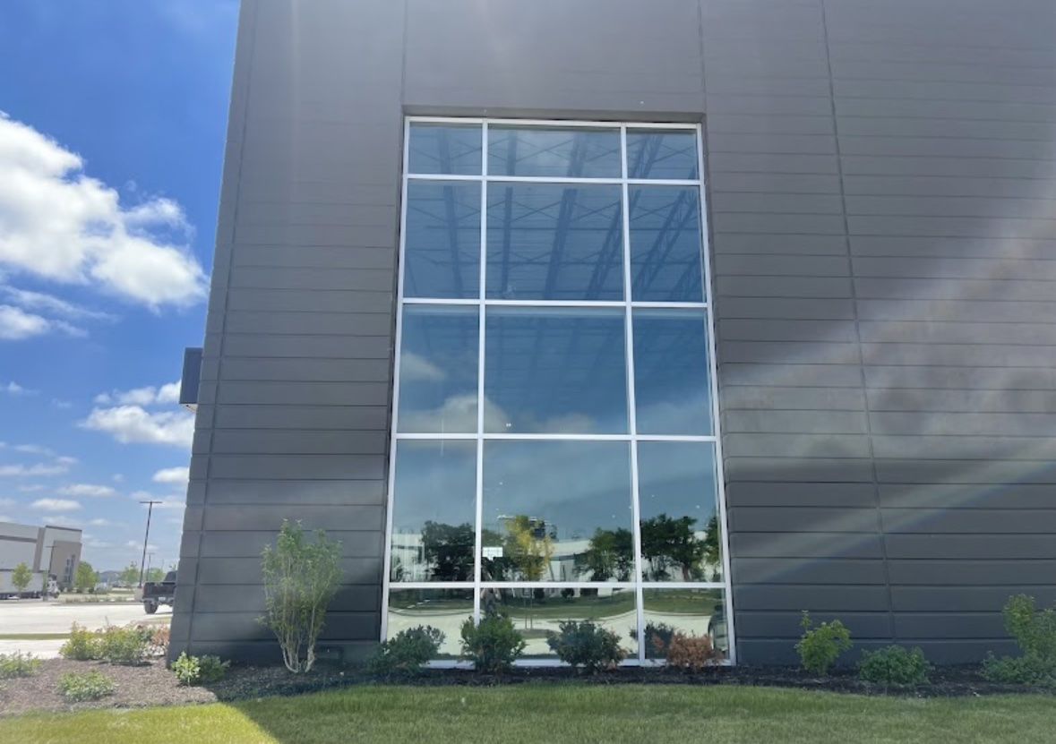 Two-story window wall with solar film